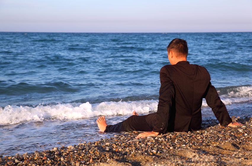 Men staring into the sea