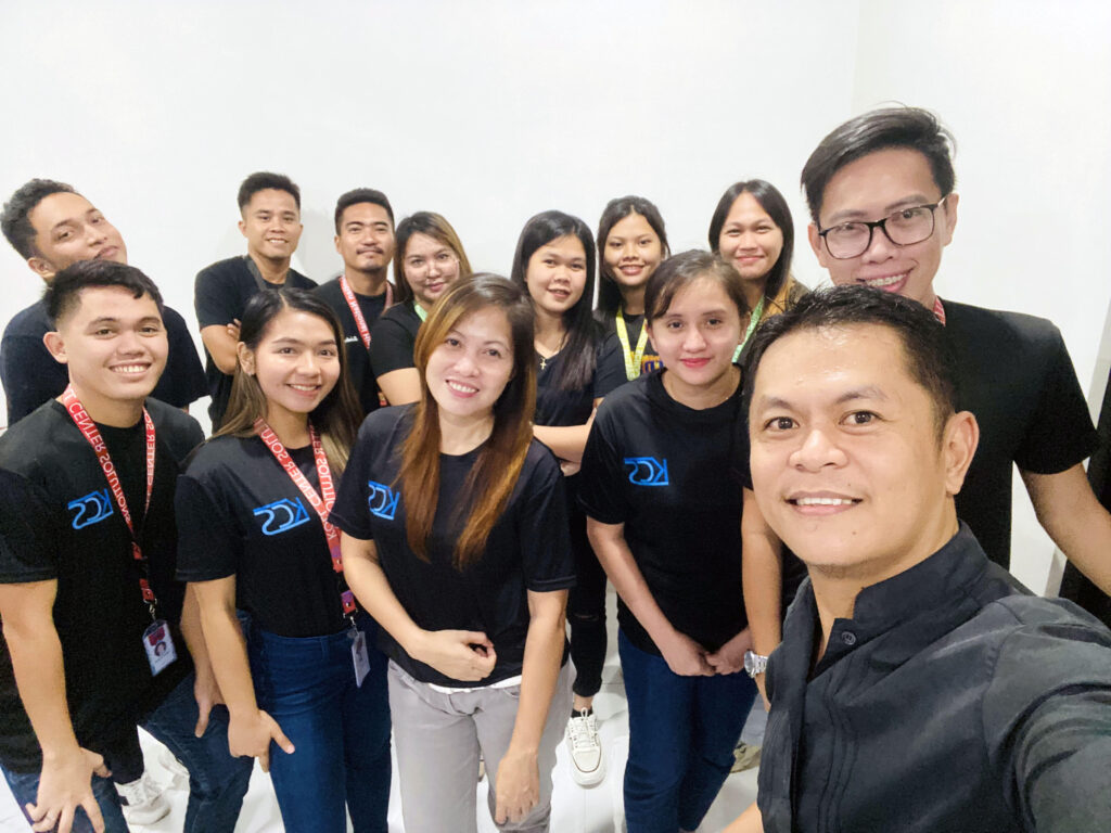 Employees taking group photo in Philippines. 